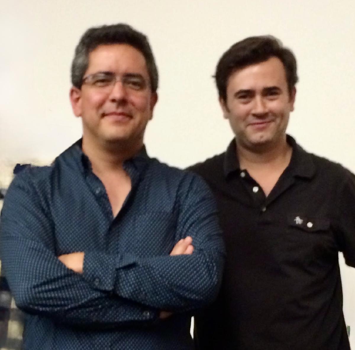Fernando Pérez and Josh Bloom smiling side by side in front of a white wall.